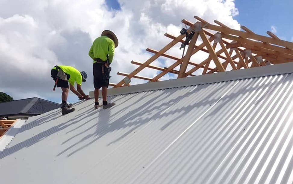 Two workers building a roof — Wilkinson Homes Pty Ltd in Annandale, QLD